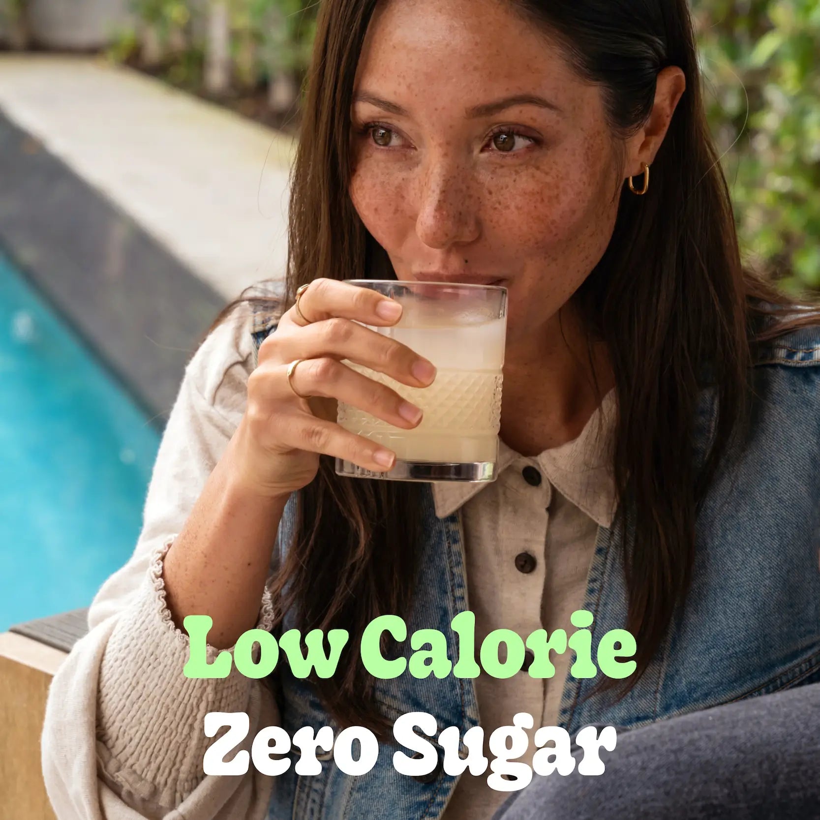 girl enjoying a sip of a classic margarita cocktail, with the words 'Low Calorie and Zero Sugar' displayed