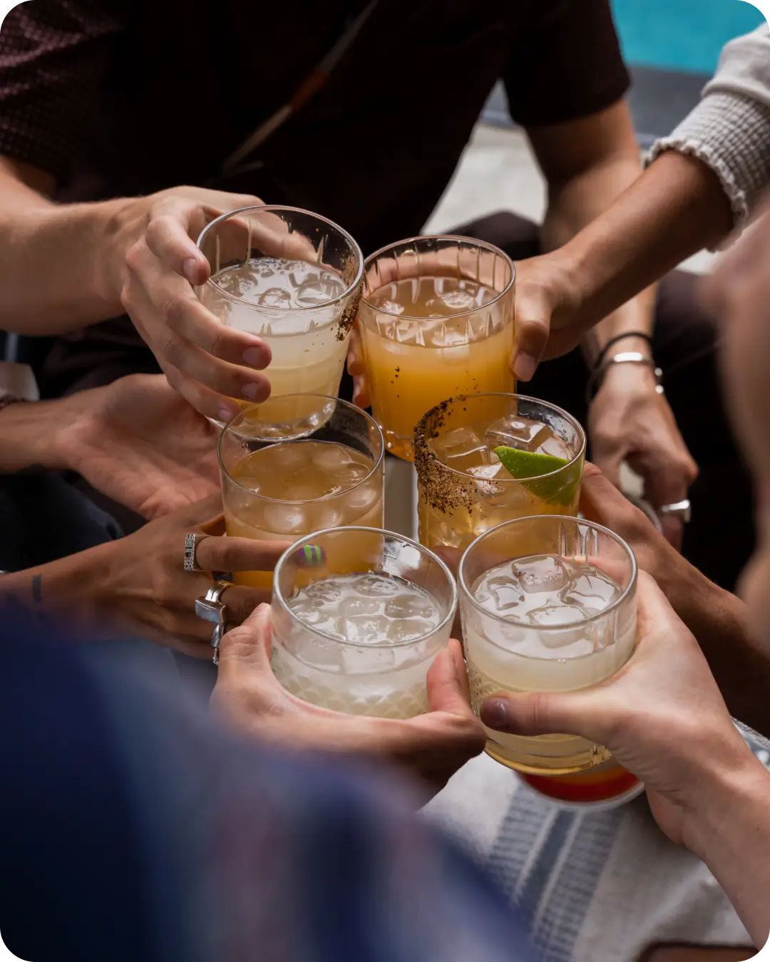 group cheers with cocktails